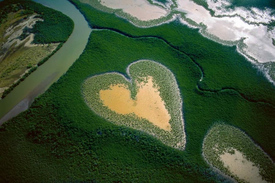 Aerial view of a heart-shaped wetland, symbolizing returning to ease and inner rhythm